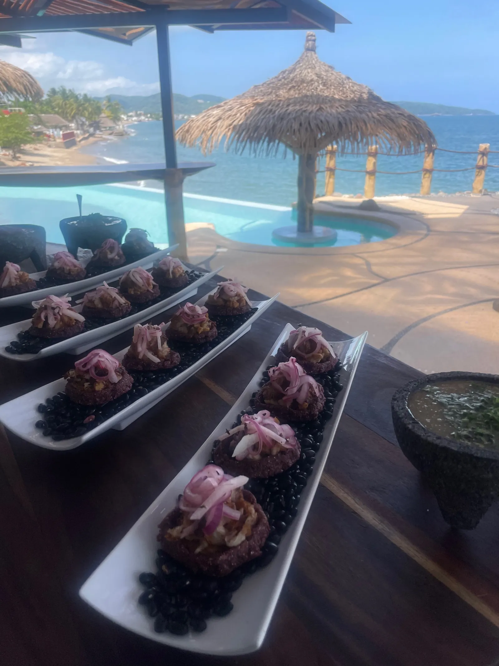 Sopes spread with panoramic beach backdrop