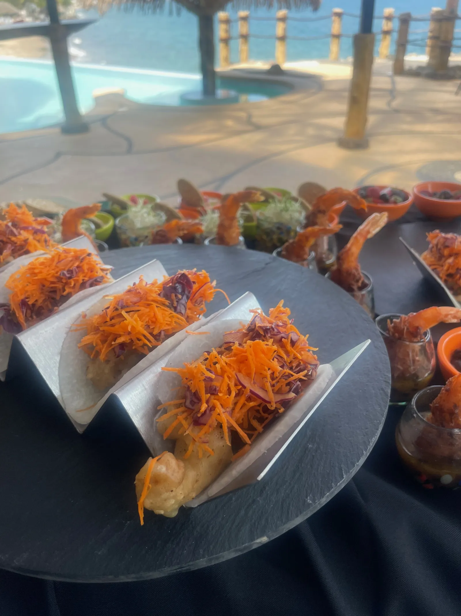 Beer-battered tacos with pool and ocean in the background